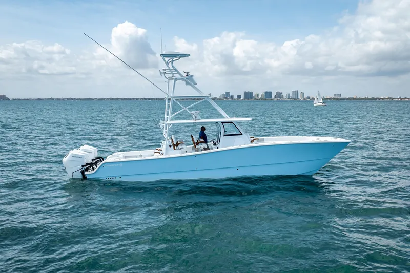 Cya Yacht Photos Pics 2025 Freeman 43 boat cruising on open water with city skyline in background.
