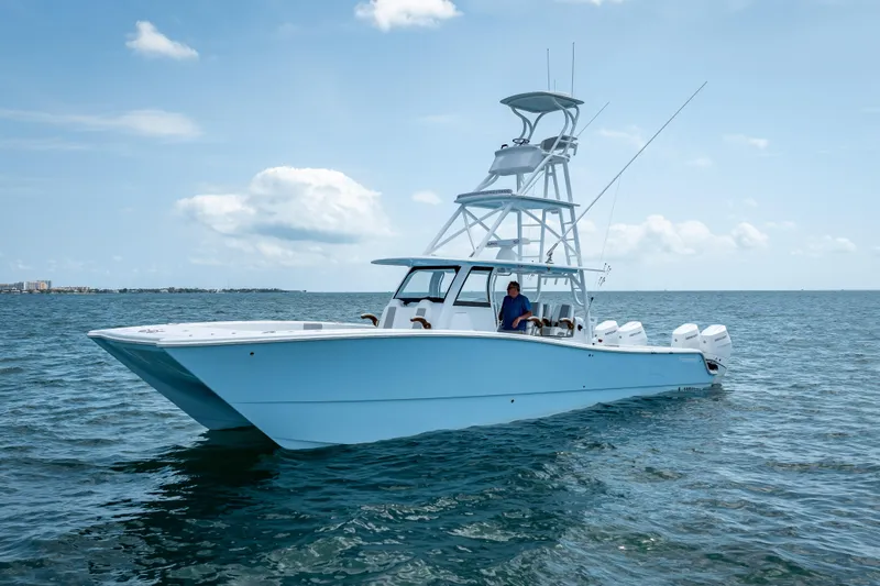 Cya Yacht Photos Pics 2025 Freeman 43 boat on open water, clear sky, multiple outboard engines.