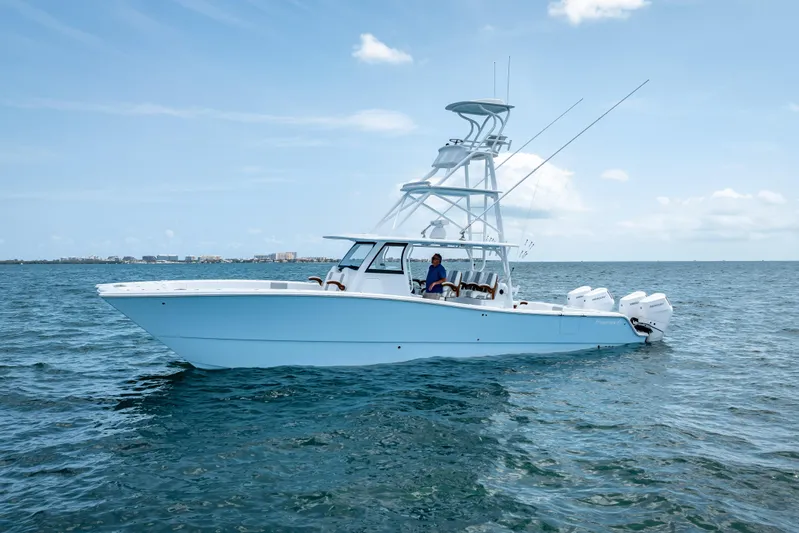 Cya Yacht Photos Pics 2025 Freeman 43 boat on open water, clear sky, multiple outboard engines.