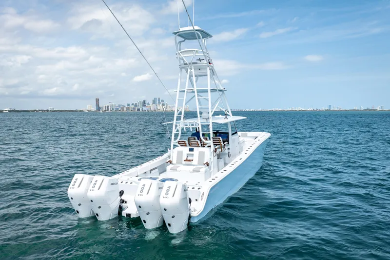 Cya Yacht Photos Pics 2025 Freeman 43 boat with four engines on open water, city skyline in background.