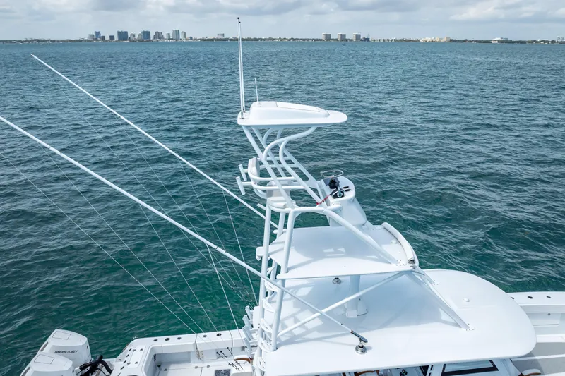 Cya Yacht Photos Pics 2025 Freeman 43 boat with tower, fishing rods, and ocean backdrop.