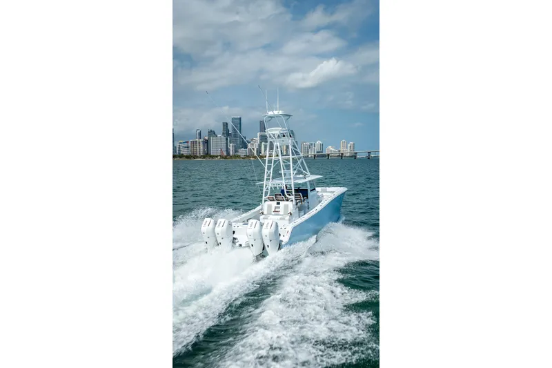 Cya Yacht Photos Pics 2025 Freeman 43 boat cruising on water with city skyline in background.