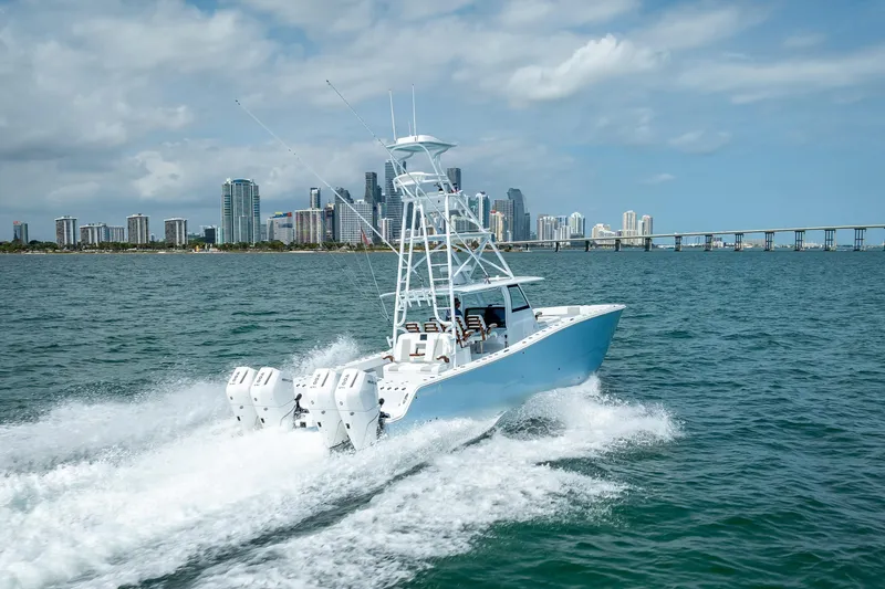 Cya Yacht Photos Pics 2025 Freeman 43 boat cruising near city skyline and bridge on a sunny day.