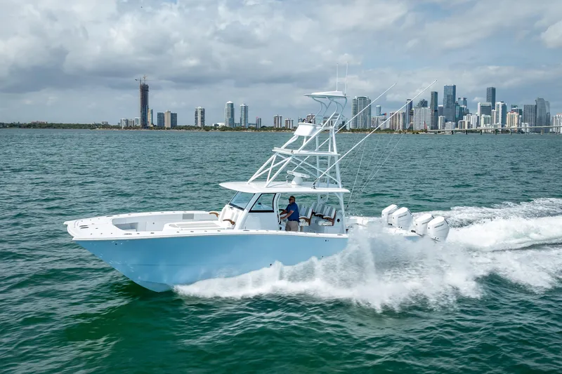 Cya Yacht Photos Pics 2025 Freeman 43 boat cruising near city skyline on a sunny day.