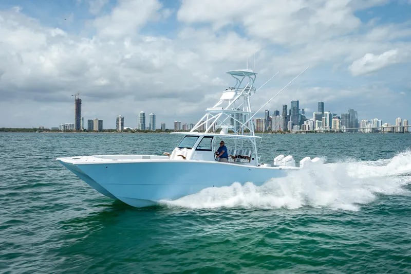 Cya Yacht Photos Pics 2025 Freeman 43 boat cruising near city skyline on a sunny day.