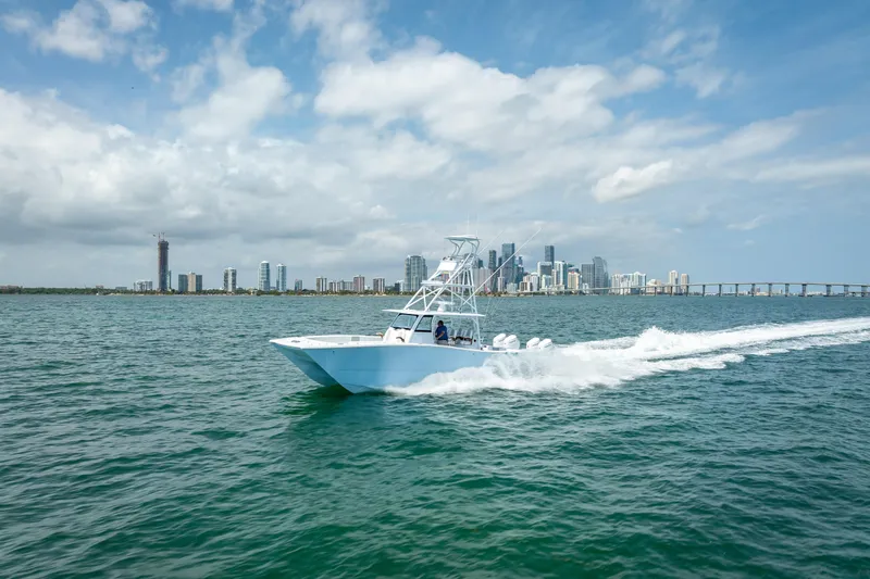Cya Yacht Photos Pics 2025 Freeman 43 boat cruising near city skyline under blue sky.
