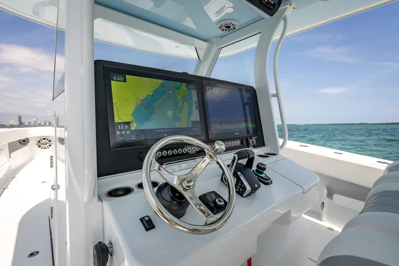 Cya Yacht Photos Pics Modern Freeman 43 boat dashboard with navigation screens, steering wheel, and ocean view, 2025 model.