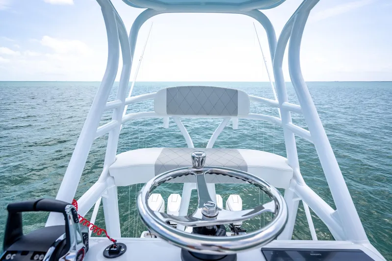 Cya Yacht Photos Pics Helm view of 2025 Freeman 43 boat on open sea, featuring modern steering and controls.