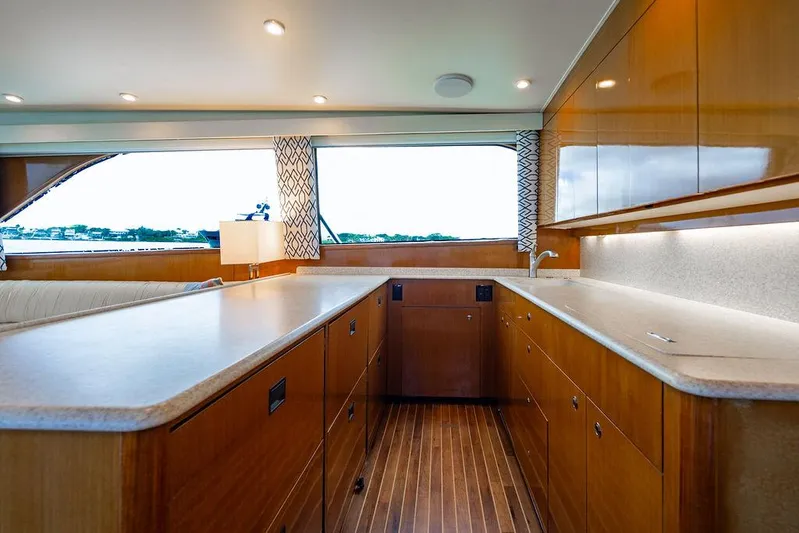  Yacht Photos Pics Interior of a 1999 Viking Convertible yacht with modern kitchen and wooden cabinetry.