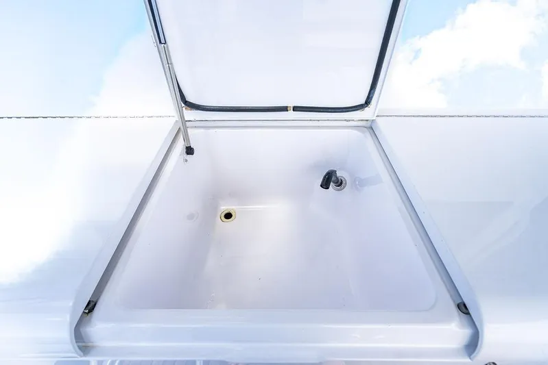  Yacht Photos Pics Open storage compartment on 1999 Viking Convertible boat, featuring a clean white interior.