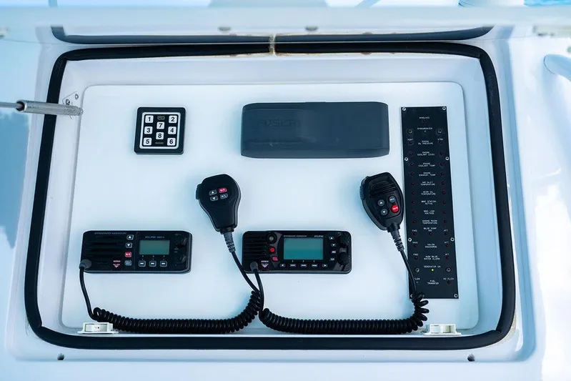  Yacht Photos Pics Control panel of a 1999 Viking Convertible boat with communication devices and keypad.