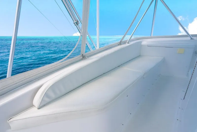  Yacht Photos Pics 1999 Viking Convertible boat interior with ocean view, featuring white seating and clear blue skies.