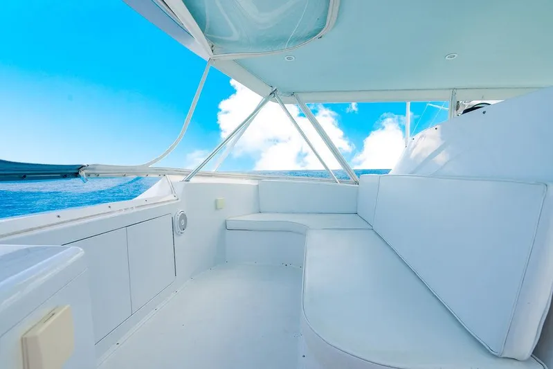  Yacht Photos Pics 1999 Viking Convertible boat interior with white seating, ocean view, and blue sky.