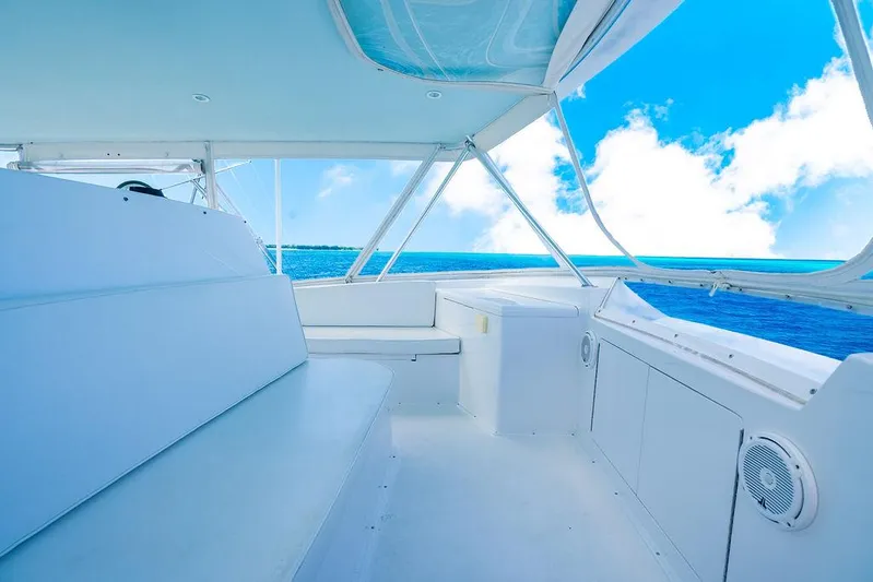  Yacht Photos Pics 1999 Viking Convertible yacht interior with ocean view, featuring white seating and clear blue skies.