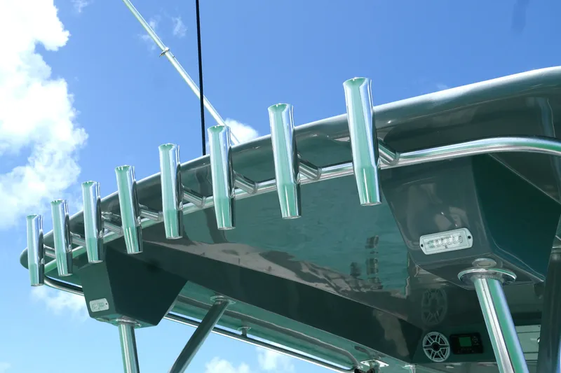  Yacht Photos Pics 2023 Prowler Renaissance Prowler 36 boat with rod holders and sleek design against blue sky.