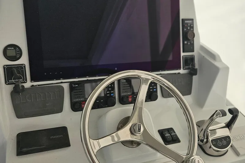  Yacht Photos Pics Control panel of a 1996 Blackfin 33 Combi boat with steering wheel and navigation equipment.