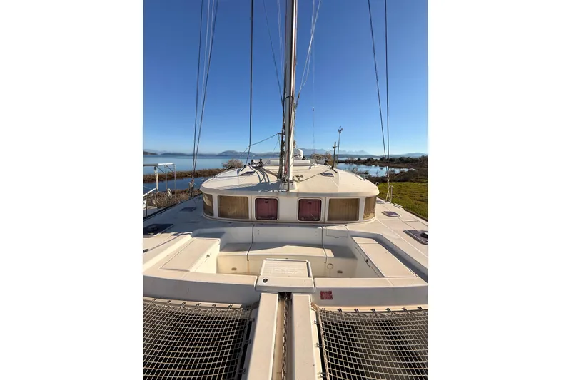  Yacht Photos Pics 2010 Lagoon 440 catamaran on calm water with clear blue sky.
