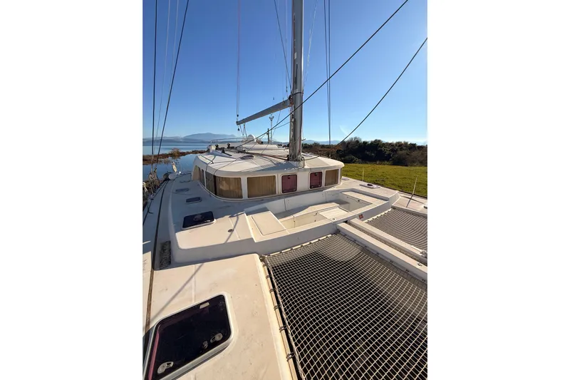  Yacht Photos Pics 2010 Lagoon 440 catamaran on calm water with clear blue sky.