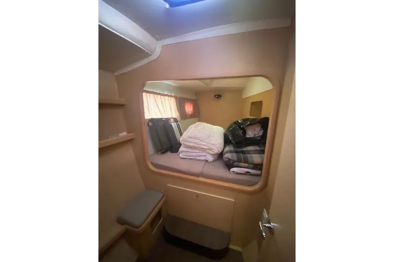  Yacht Photos Pics Interior cabin of 2010 Lagoon 440 catamaran with bed and storage space.