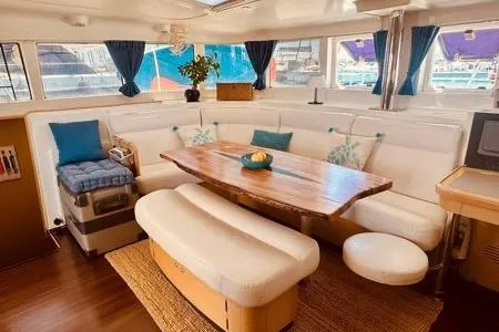  Yacht Photos Pics Luxurious interior of 2010 Lagoon 440 catamaran with elegant seating and wooden table.