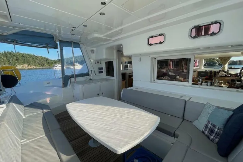  Yacht Photos Pics Spacious interior of 2010 Lagoon 440 catamaran with seating and scenic water view.