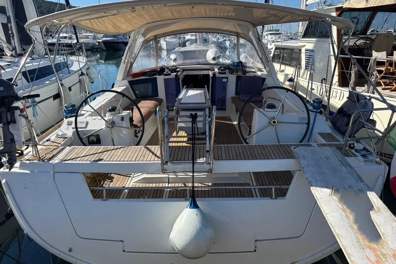  Yacht Photos Pics 2019 Beneteau Oceanis 45 sailboat with dual steering wheels in a marina.