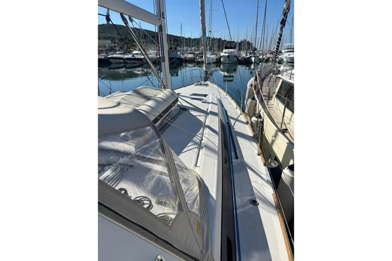  Yacht Photos Pics 2019 Beneteau Oceanis 45 sailboat docked in a marina, surrounded by other vessels.