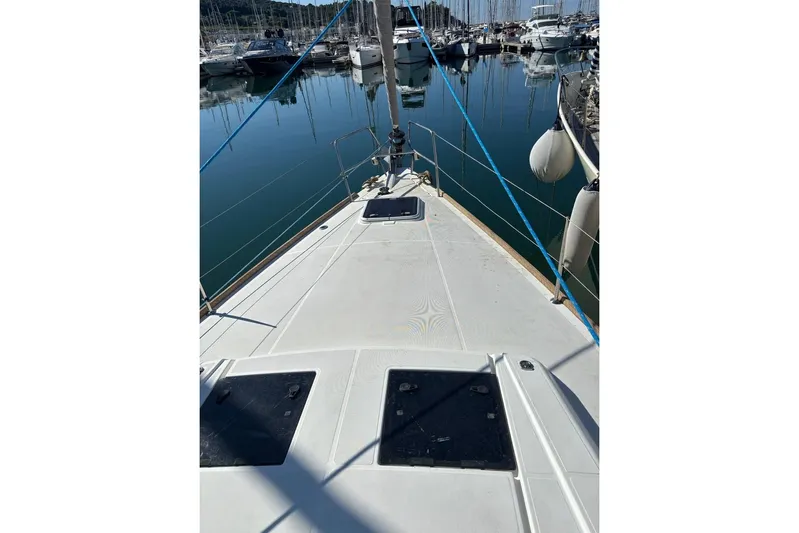  Yacht Photos Pics 2019 Beneteau Oceanis 45 sailboat deck in marina, showing clean lines and moored yachts.