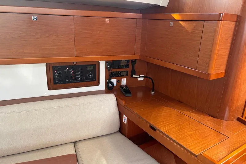  Yacht Photos Pics Interior of 2019 Beneteau Oceanis 45 yacht with wooden cabinetry and navigation controls.