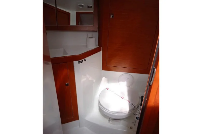  Yacht Photos Pics Bathroom interior of 2019 Beneteau Oceanis 45 yacht, featuring wooden cabinetry and modern fixtures.