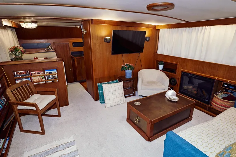 Camelot Yacht Photos Pics 1976 Pacemaker 65 yacht interior with cozy living area, wooden furniture, and modern amenities.