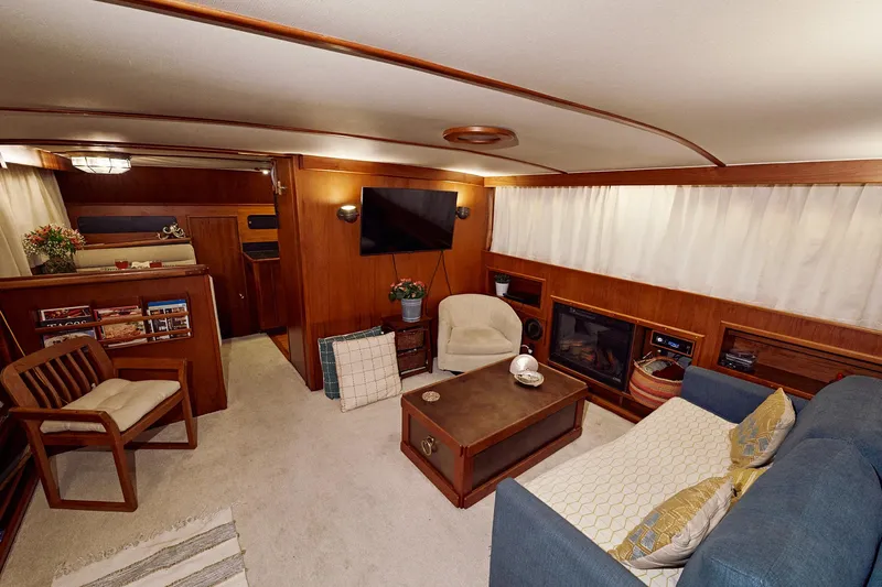 Camelot Yacht Photos Pics 1976 Pacemaker 65 yacht interior with cozy living area, wooden accents, and modern amenities.