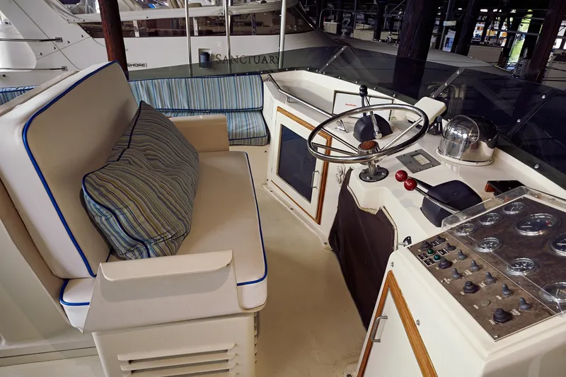 Camelot Yacht Photos Pics 1976 Pacemaker 65 yacht helm station with steering wheel and control panel.