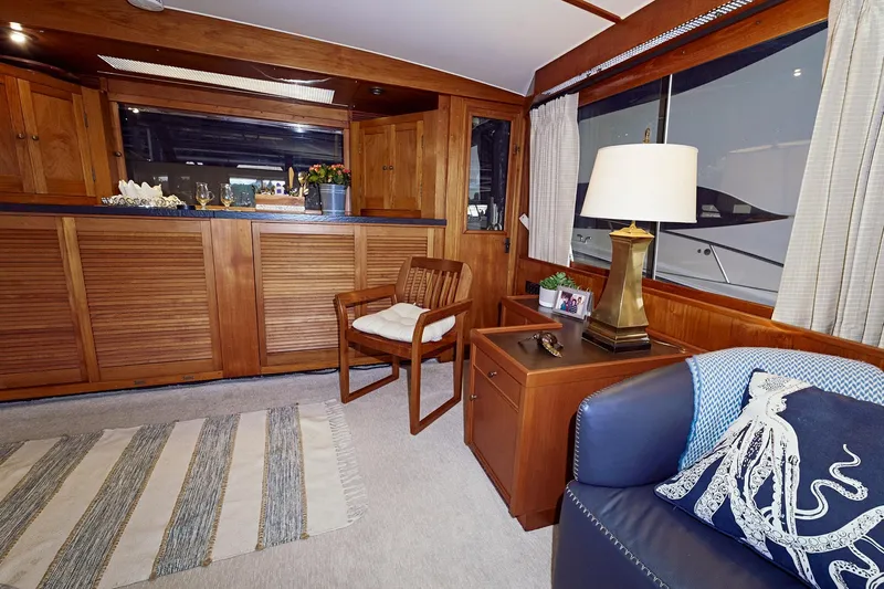 Camelot Yacht Photos Pics Interior of a 1976 Pacemaker 65 yacht with wooden furnishings and nautical decor.