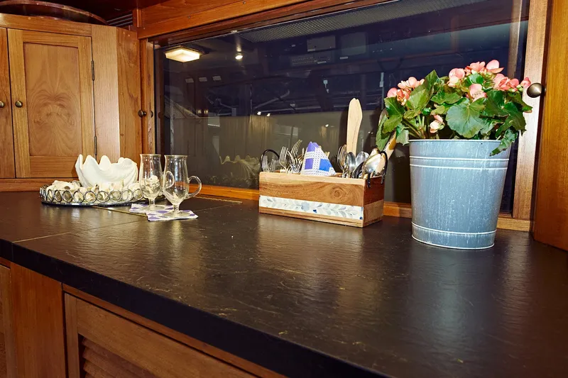 Camelot Yacht Photos Pics 1976 Pacemaker 65 kitchen counter with flowers, utensils, and glassware.