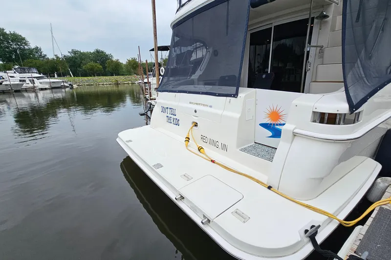  Yacht Photos Pics 2007 Silverton 38 Sport Bridge docked, featuring "Don't Tell the Kids" text on the stern.