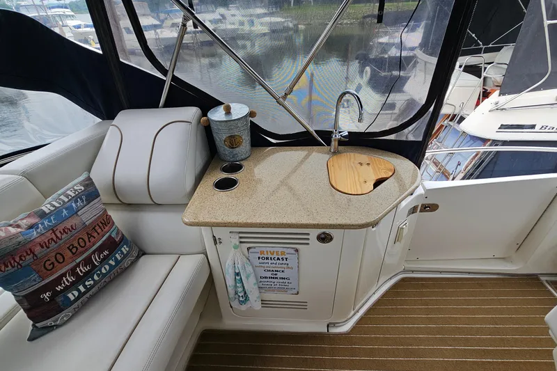  Yacht Photos Pics 2007 Silverton 38 Sport Bridge interior with kitchenette, sink, and decorative pillows.