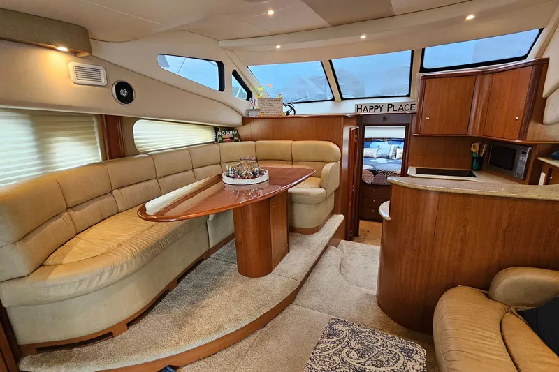  Yacht Photos Pics Luxurious interior of 2007 Silverton 38 Sport Bridge yacht with elegant seating and dining area.