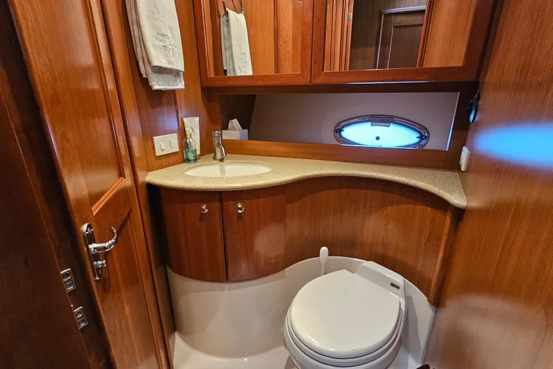 Yacht Photos Pics Luxurious 2007 Silverton 38 Sport Bridge yacht bathroom with wood cabinetry and modern fixtures.