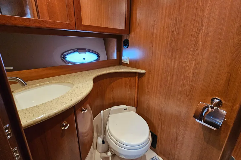  Yacht Photos Pics Luxurious 2007 Silverton 38 Sport Bridge yacht bathroom with wood finish and modern amenities.