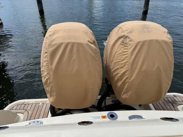  Yacht Photos Pics Twin covered engines on a 2018 Chris-Craft Catalina 30 boat at a dock.