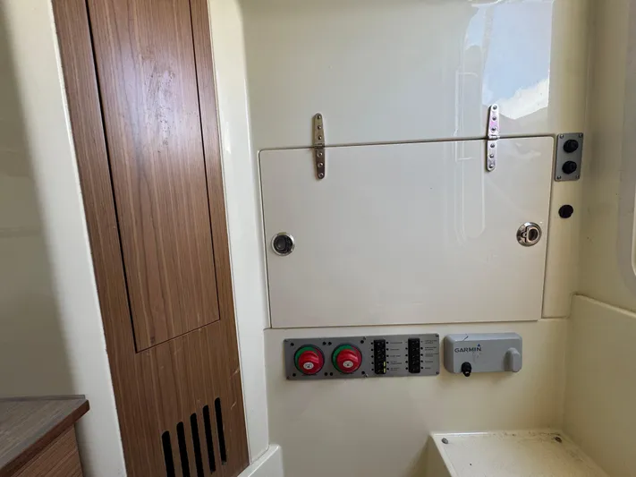  Yacht Photos Pics 2018 Chris-Craft Catalina 30 interior with control panel and wooden accents.