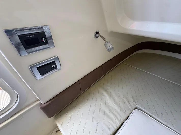  Yacht Photos Pics Interior of 2018 Chris-Craft Catalina 30, featuring control panel and cushioned seating.