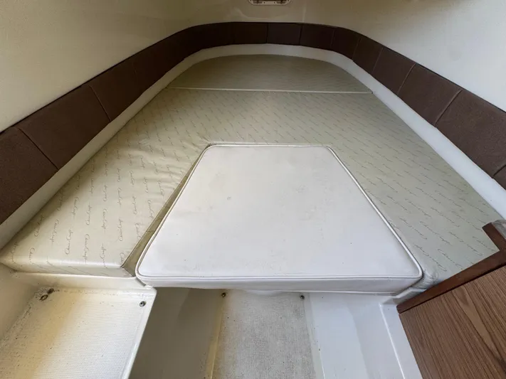  Yacht Photos Pics 2018 Chris-Craft Catalina 30 cabin interior with cushioned seating and wooden accents.