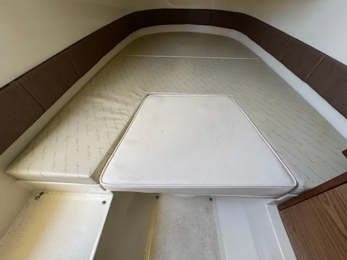  Yacht Photos Pics 2018 Chris-Craft Catalina 30 cabin interior with cushioned seating and brown accents.