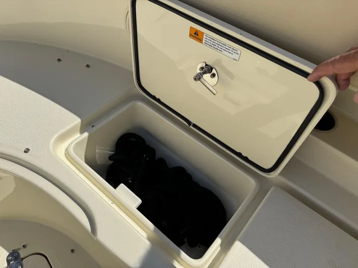  Yacht Photos Pics 2018 Chris-Craft Catalina 30 storage compartment with open hatch, showcasing interior space.