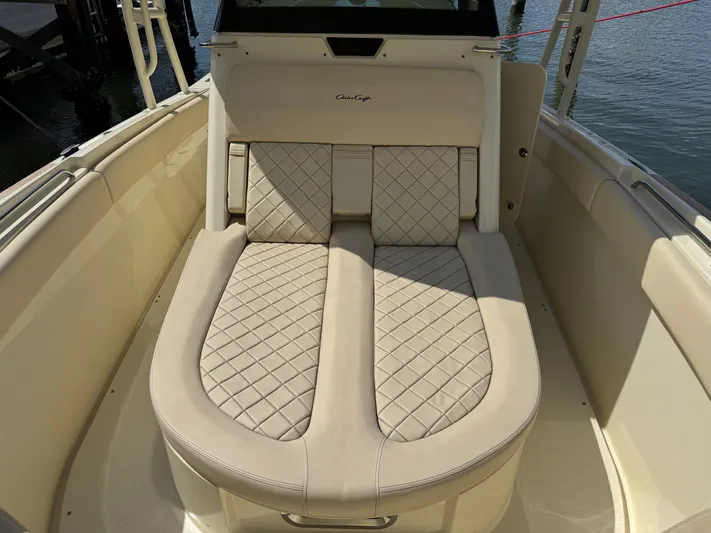  Yacht Photos Pics 2018 Chris-Craft Catalina 30 boat with beige quilted seating, docked by the water.