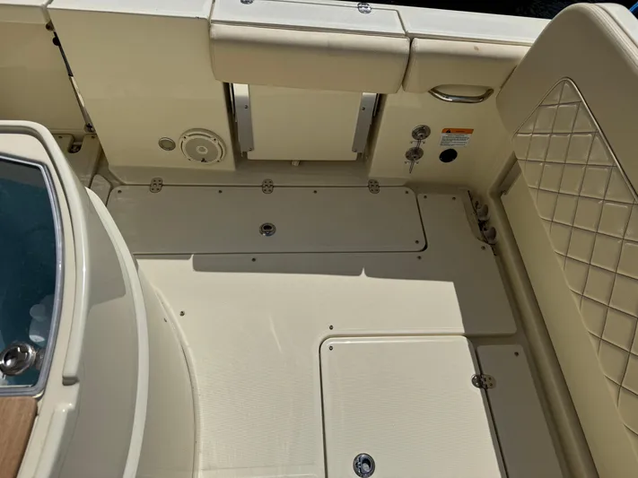  Yacht Photos Pics 2018 Chris-Craft Catalina 30 boat interior with beige seating and storage compartments.