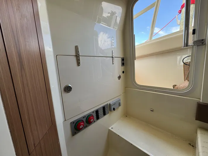  Yacht Photos Pics Interior view of a 2018 Chris-Craft Catalina 30 boat, featuring control panel and seating.