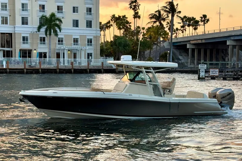  Yacht Photos Pics 2018 Chris-Craft Catalina 30 boat cruising near a waterfront at sunset.